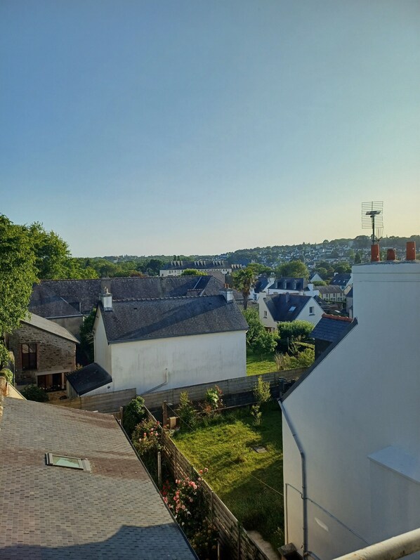 A residential area with houses, a grassy yard, and a clear sky.