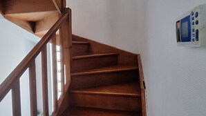 A wooden staircase with a handrail, leading to a landing. - House for rent near Paris (Livry-Gargan)