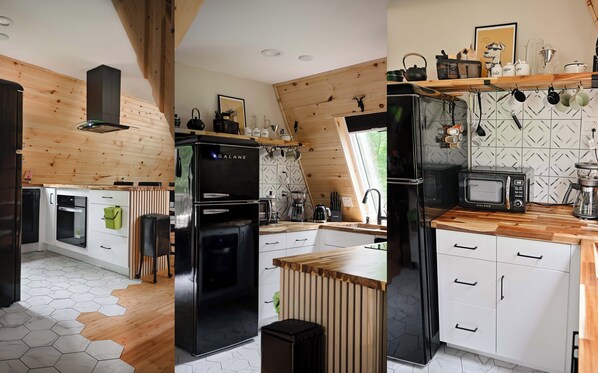 A modern kitchen with wooden accents, a black Galanz refrigerator, a microwave, and a coffee maker.