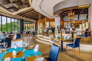 A spacious restaurant with high ceilings, large windows, and a modern interior design. - Luxe Beachfront Retreat at Garza Blanca w/Panoramic Mountain & Ocean Views, PV (Puerto Vallarta)