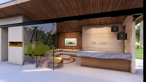 A reception area with a reception desk, a sofa, and a framed picture on the wall. - Royal Grand Resorts (Quepos)