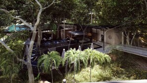 A modern outdoor lounge area with seating and a pool, surrounded by lush greenery and trees. - Royal Grand Resorts (Quepos)