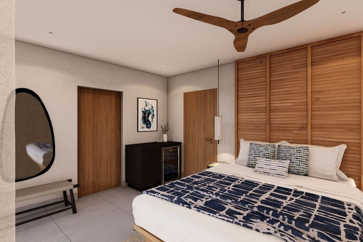 A modern bedroom with a large bed, wooden headboard, ceiling fan, bedside lamps, and a mirror.