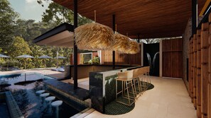 A modern outdoor bar area with a pool, lounge chairs, and a thatched roof. - Royal Grand Resorts (Quepos)