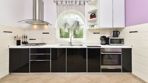 A compact kitchen with a gas stove, sink, and integrated oven. - Apartment 2399/160967 (Istria - Rakalj), 800m from the beach (Rakalj)