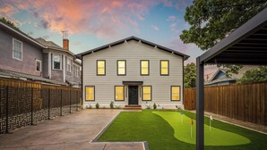 A two-story house with a front yard and a covered patio area. - Moroccan-Inspired 1-BR Getaway near Reunion Tower (Dallas)