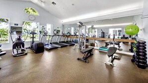 A gym with treadmills, elliptical machines, free weights, and exercise balls. - Relaxing Modern 4BR Family Oasis in Napes- 10 Min to Beach & Downtown Fun (Naples)