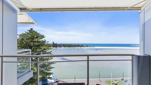 A balcony with a view of a beach and ocean. - The Entrance Waterfront Apartment 505 (The Entrance)