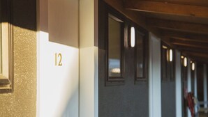 A corridor with a number '12' on a wall, indicating a room number. - The Turoa Lodge Ohakune (Ohakune)