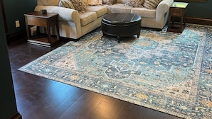 A living room with a sectional sofa, a coffee table, and a patterned rug. - A Peaceful Driftless Farm Stay Awaits Near A Trout Stream (Muscoda)