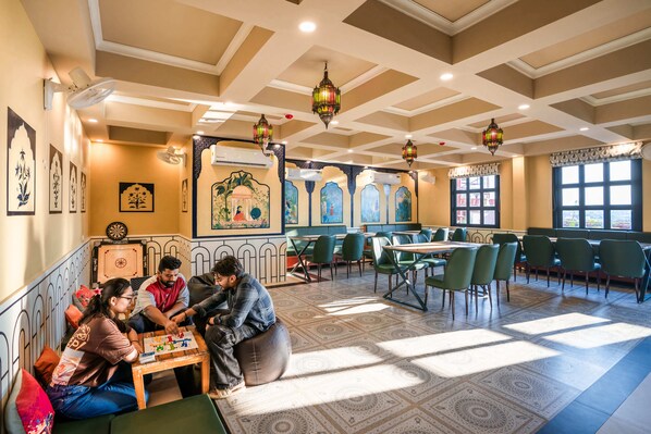 A restaurant with a high ceiling, patterned floor, and traditional decor. - Zostel Agra (Agra)