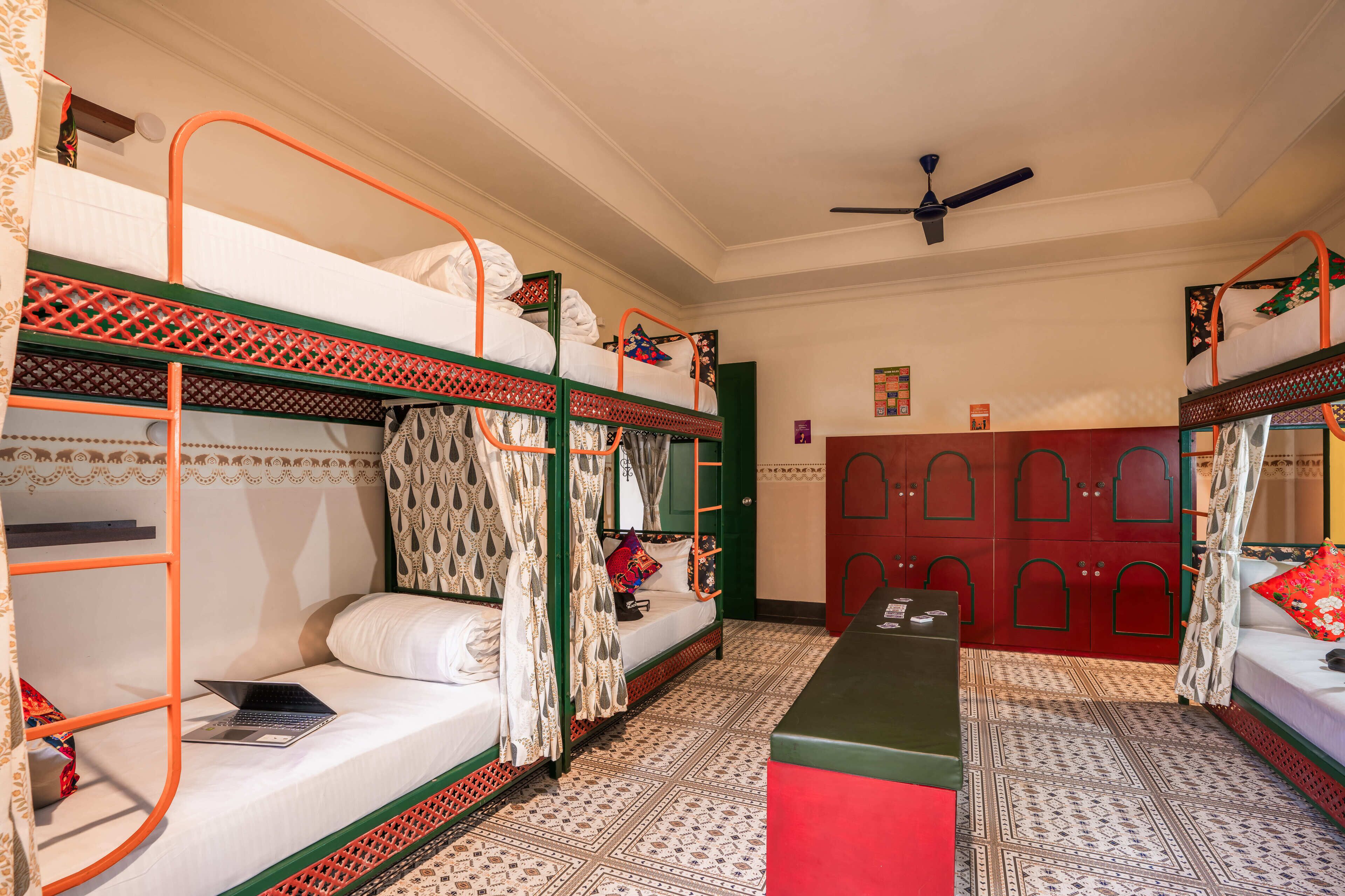 A room with bunk beds, a desk, and a wardrobe.