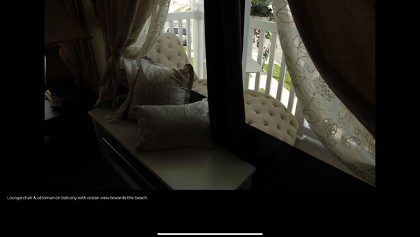 A lounge chair and ottoman on a balcony with an ocean view towards the beach. - Charming 2-bedroom apartment in Arverne by the Sea (Arverne)