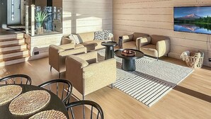 A modern living room with a sofa set, coffee table, and a TV mounted on the wall. - Villa haave by Interhome (Kustavi)