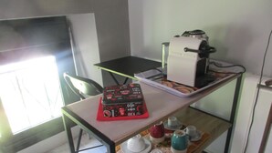 A small kitchenette with a coffee maker, a kettle, and a cup on a tray. - Etape Sologne, flexible accommodation (Neuvy-sur-Barangeon)