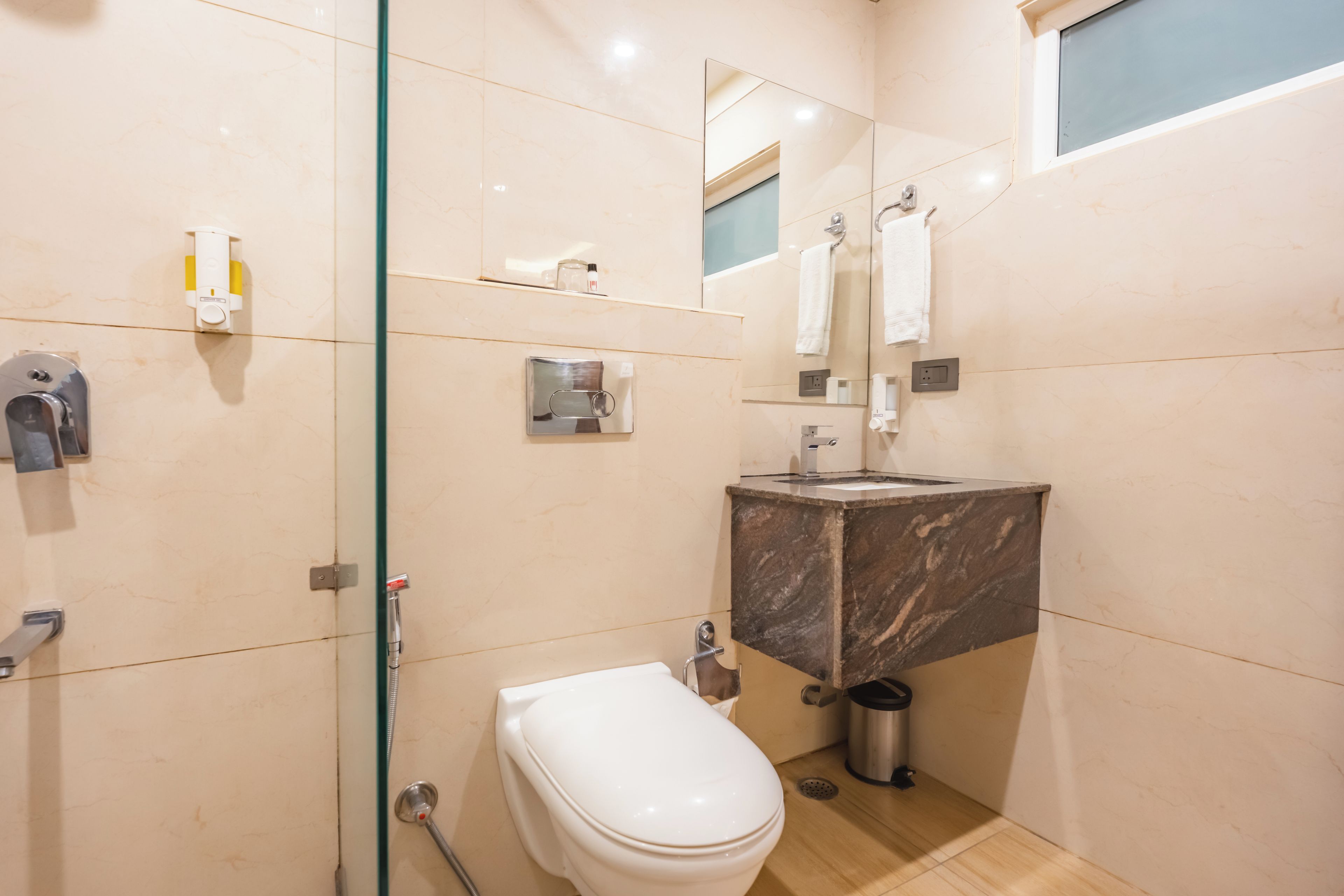 A modern bathroom with a toilet, sink, and shower.