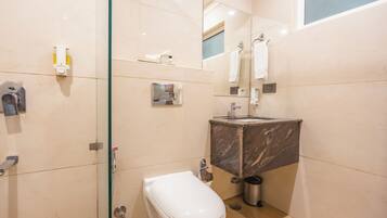 A modern bathroom with a toilet, sink, and shower.