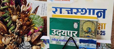 A collection of books and decorative items on a wooden surface.