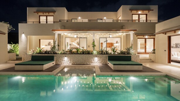 A modern two-story house with a swimming pool, outdoor lighting, and a well-maintained garden. - Rumah Tiha by Alfred in Bali (Canggu)