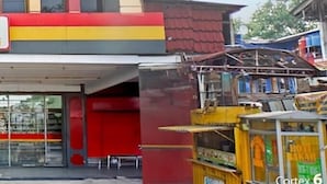 A multi-story building with a flat roof, large windows, and a red and yellow facade.