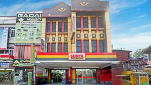 A multi-story building with a prominent 'Surya Pasar Swalayan' sign at the ground level.