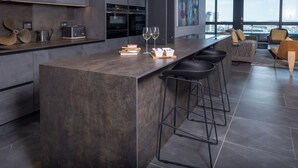 A modern kitchen with a large island, bar stools, and a city view. - The Halyard Apartments  (Cape Town)