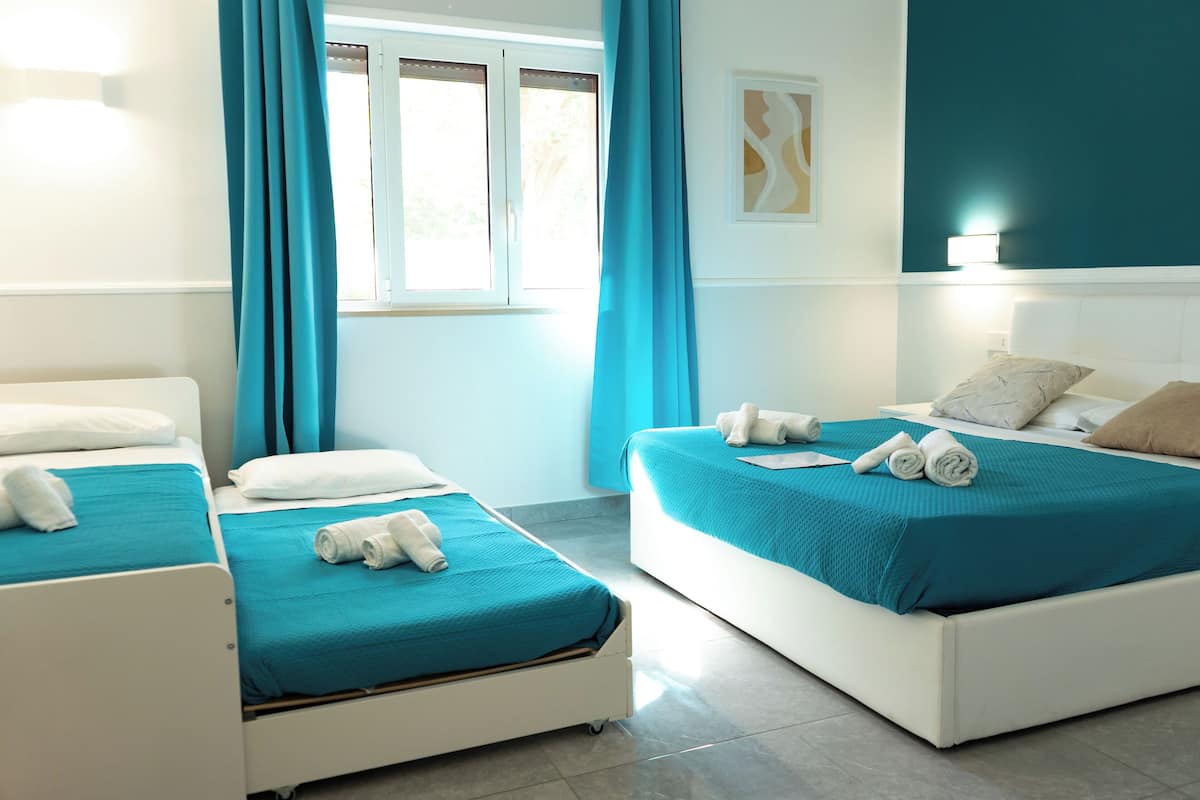 Deluxe Quadruple Room, Garden View | Premium bedding, memory-foam beds, minibar, blackout curtains