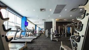 A gym with treadmills, weight machines, and exercise equipment.