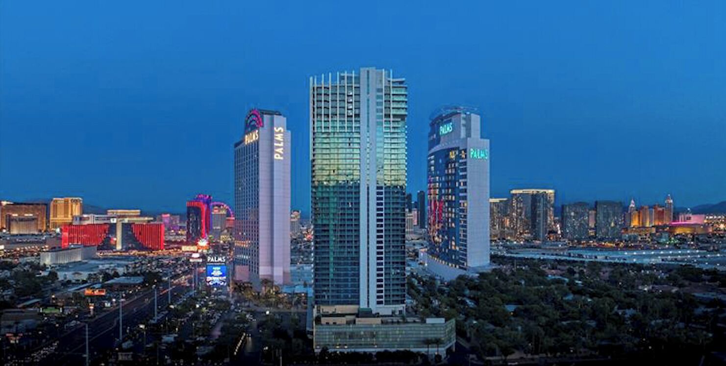 A cityscape with prominent high-rise buildings, including a hotel with a 'PALMS' sign.
