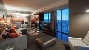 A modern hotel room with a living area, a dining space, and a large balcony with a city view. - Palms Luxury Strip View 1BD/1.5BA Open Balcony#29KA (Las Vegas)