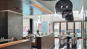 A modern restaurant with a wet floor, indicating recent cleaning or rain. - Palms Luxury Strip View 1BD/1.5BA Open Balcony#29KA (Las Vegas)