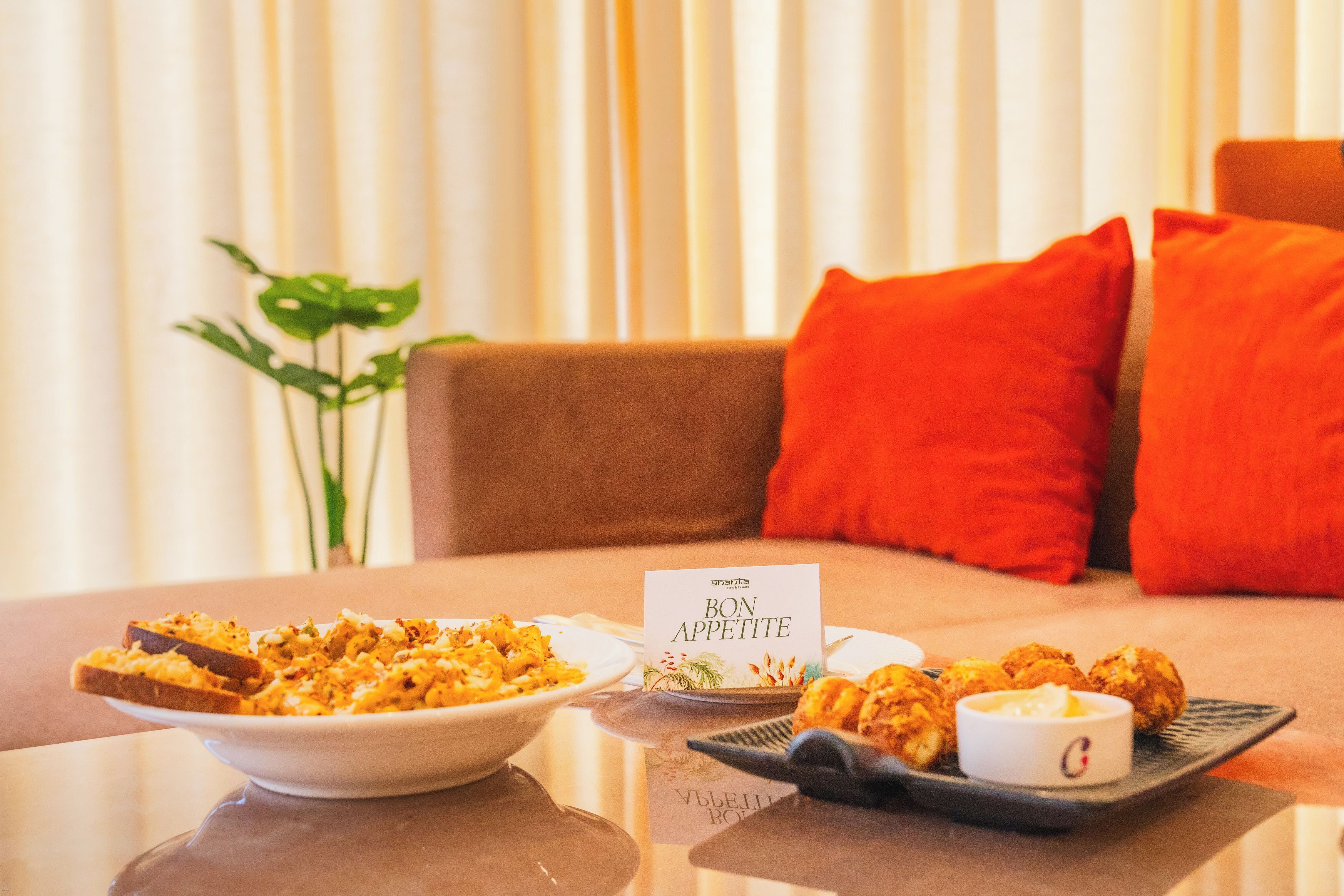 Una mesa de comedor con un plato de comida, un bol de comida y un cartel que dice 'BON APPETITE'.