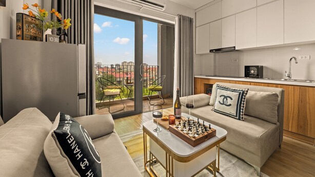 A modern apartment with a living area, kitchen, and balcony with a city view. - The West Lake Serenity'N Homestay Ha Noi (Hanoi)