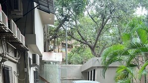 A paved driveway leading to a parked car. - Hotel T2 Grand (Mumbai)