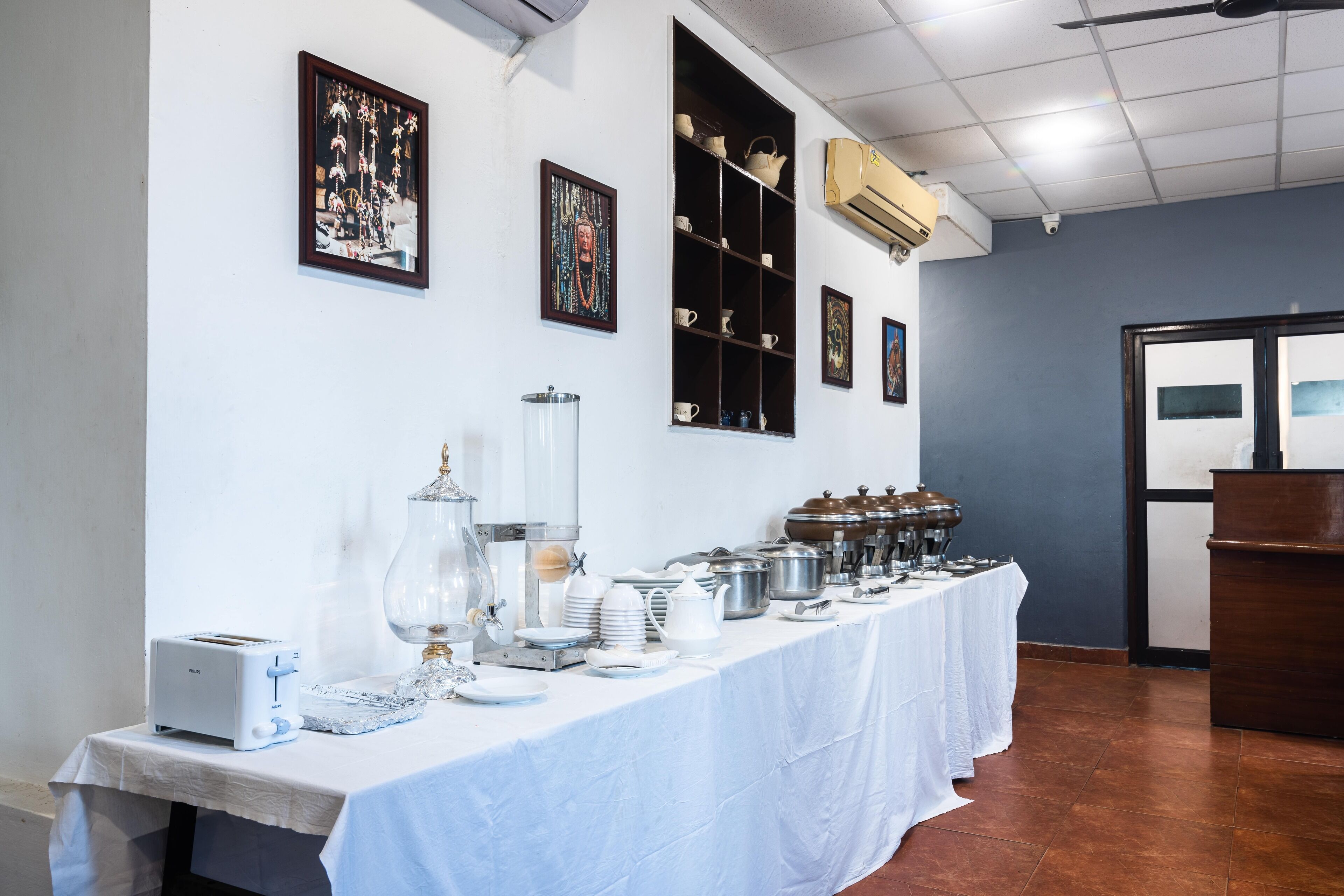 A buffet setup with a long table, various dishes, and a coffee station.