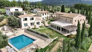 A residential area with multiple houses, a swimming pool, and a well-maintained garden. - Borgo del Lago (San Gemini)