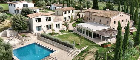 A residential area with multiple houses, a swimming pool, and a well-maintained garden.