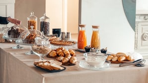 A breakfast buffet with various pastries, bread, and beverages. - Borgo del Lago (San Gemini)