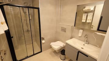 Shower, hair dryer, slippers, towels