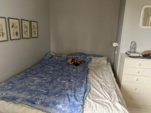 A bedroom with a bed, a dresser, and a wall with framed botanical prints. - 5 Person Holiday Home in Varmdo (Värmdö)