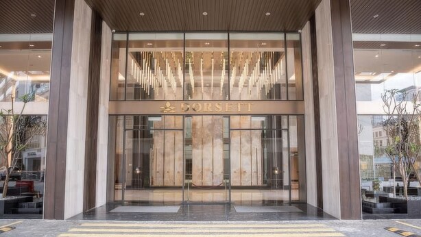 A modern building entrance with a glass facade and the name "CORSETT" displayed prominently. - KL Staycation Gateway Residences (Kuala Lumpur)