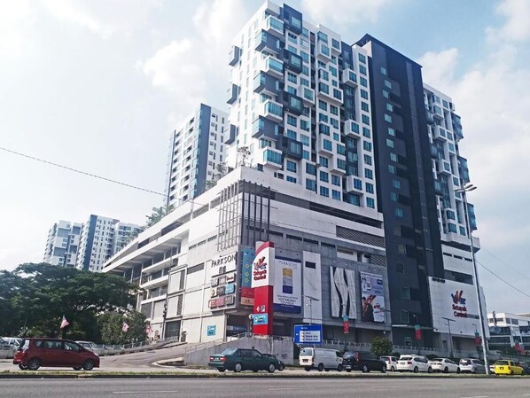 A multi-story building with a modern architectural design, featuring a prominent 'Parkson' sign on the ground floor. - Zetapark Condominium by Emily in Town (Kuala Lumpur)