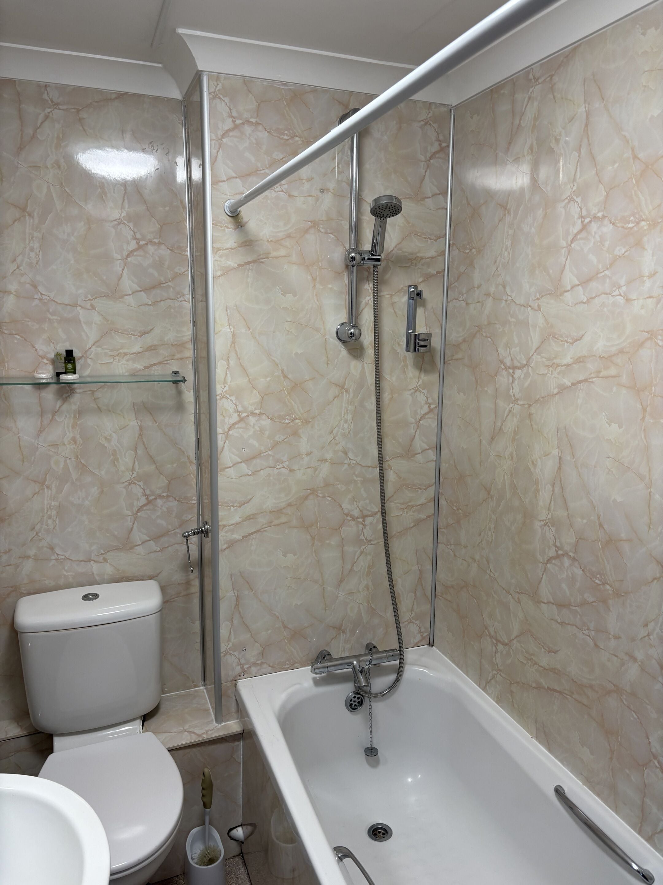 Combined shower/bathtub, towels, toilet paper