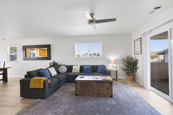 Living room with large sectional, smart TV and games