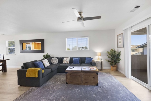 Living room with large sectional, smart TV and games