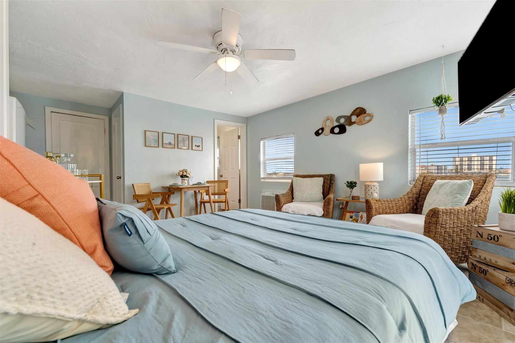 Sink into comfort in this breezy coastal bedroom, where soft blue tones and woven textures invite you to unwind. Your retreat awaits with a cozy king bed, charming dining nook, and serene views just beyond the window.