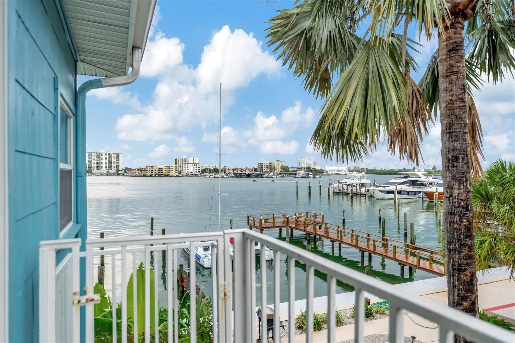 Waterfront living with swaying palms and a private dock just steps from your door—this is where your coastal escape begins.