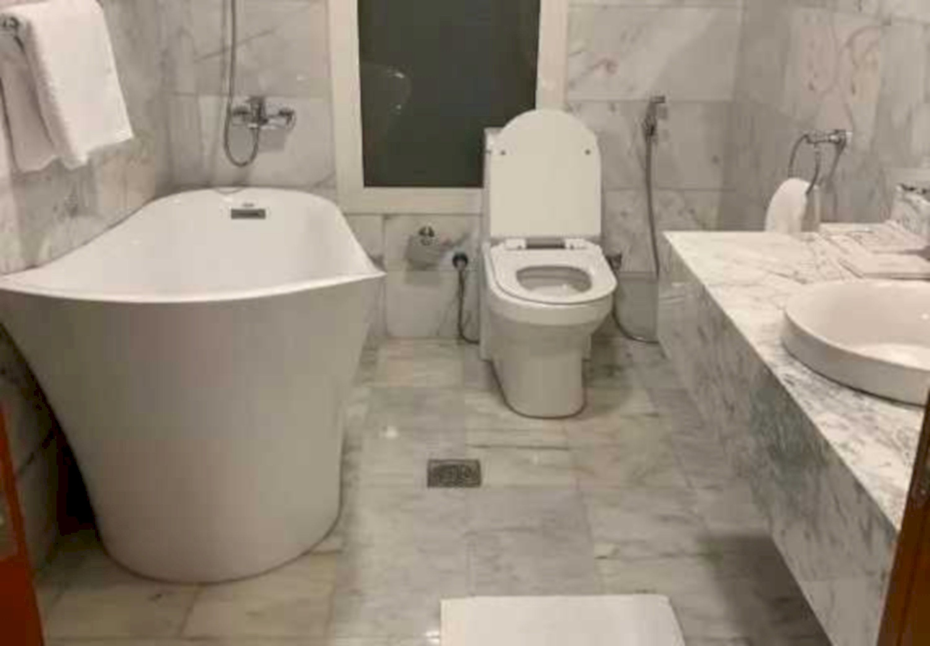 A bathroom with a bathtub, toilet, and sink.