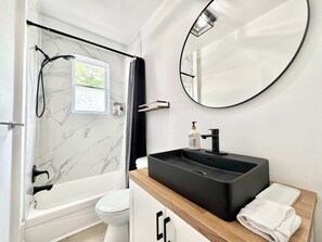 Shower, hair dryer, towels, shampoo