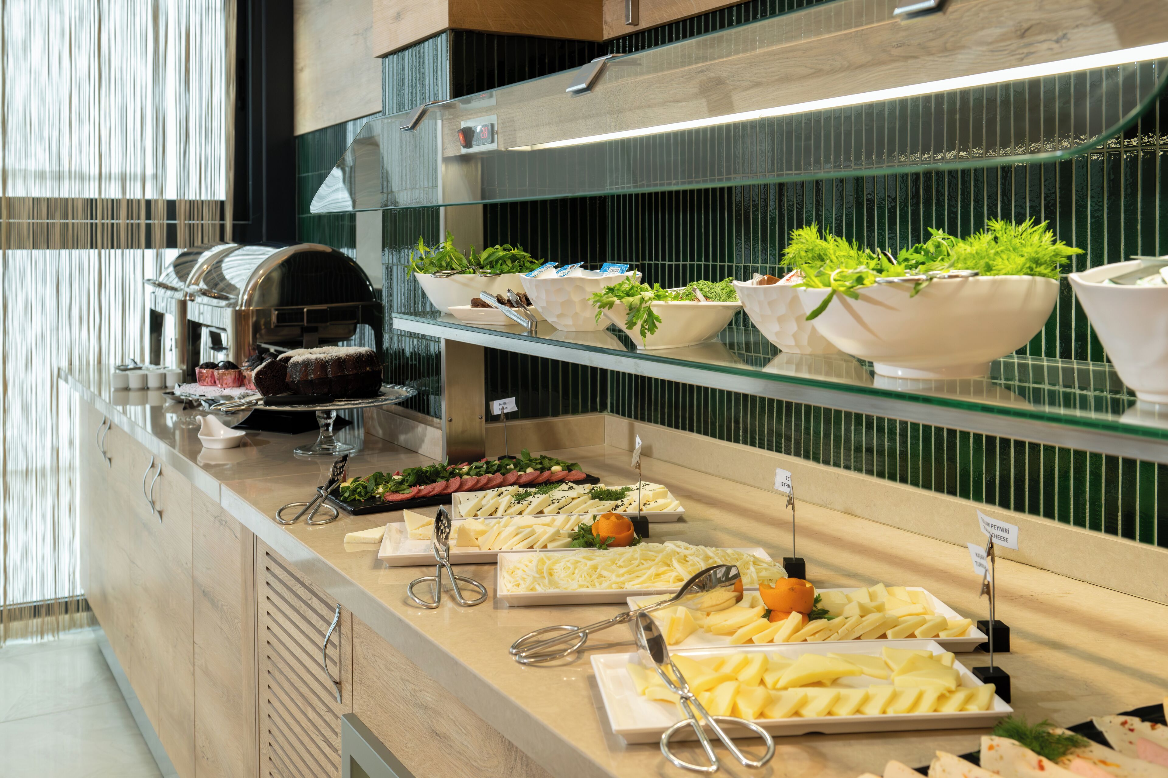 A buffet with various food items and utensils.